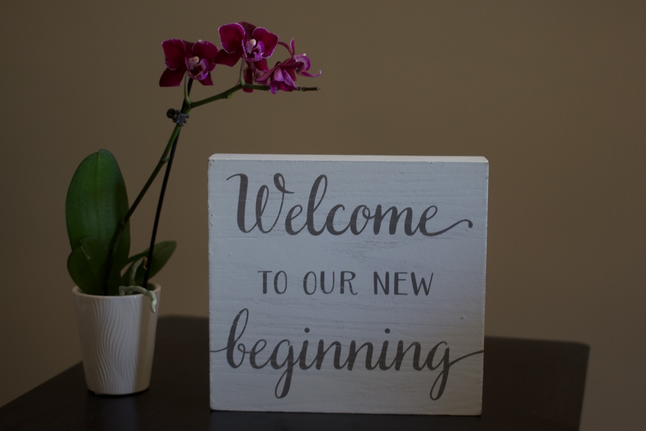 Welcome to our new beginning sign with orchid in the office